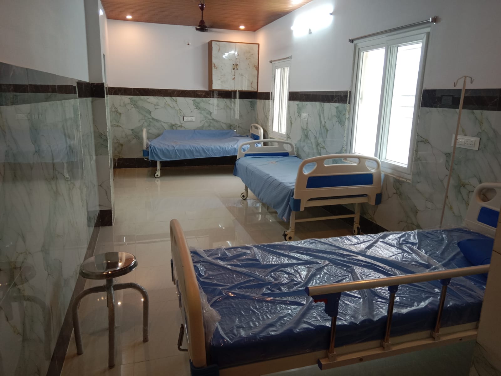 Patient room beds at Dr. Naidu Hospital Yeleswaram